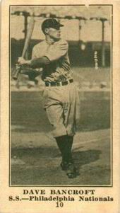 A sepia-toned baseball card of a player swinging his bat at a pitch.