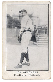 A black and white baseball card of a man in a light baseball uniform with dark socks and cap
