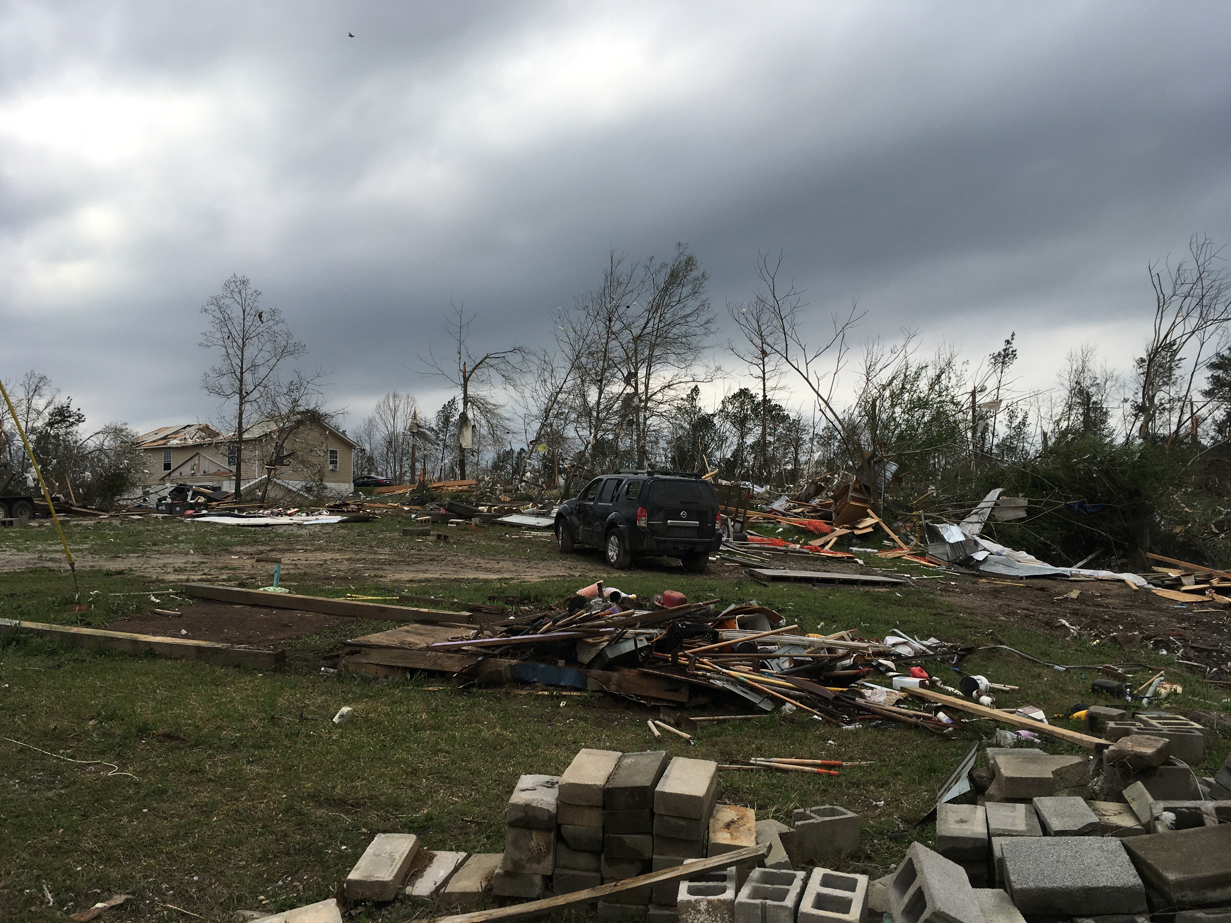 EF2 damage to home with debris in the yard and trees near Ashby, AL caused by the EF3 Sawyerville tornado.