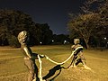 Child sculptures in the park at night