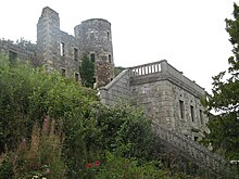 photo of steps leading to terrace with three storey ruins of round tower behind