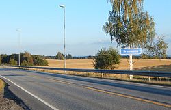 View of the sign on the road entering the village