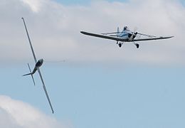 The Swift Aerobatic Display Team at Kemble Battle of Britain Weekend 2009. A Swift S-1 is performing continuous rolls while towed by a Piper Pawnee