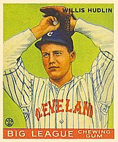 Baseball card image of a man in baseball uniform preparing to throw a pitch