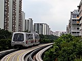 A Bombardier Innovia APM 100 C801A running on the guiderails, in the new SMRT livery.