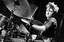 Photograph of a female drummer in performance