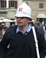 Florence (Italy) municipal police officer wearing white crest-style custodian helmet.