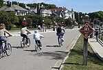 Bikers on M-185 at mile marker 0 in downtown Mackinac Island