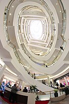 Interior atrium of Nordstrom store with curved escalators, 2011