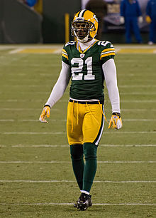 Woodson standing on a football field in his Packers uniform