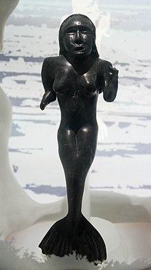 Carving of Sedna, depicted with her legs turned into the tail of a fish, and her fingers cut off.