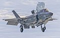 An F-35B hovering over the USS America