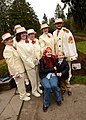 Female World War II veteran Ada Wyn Parker poses for a photo with a group of Rosarians