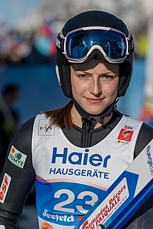 Woman in black and white top with black helmet
