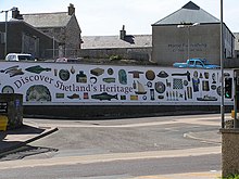 A mural with the text "Discover Shetland's Heritage" and images of archaeological and craft objects