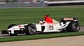 Jacques Villeneuve driving the BAR 005 with non-tobacco livery replaced with bar code and F1 cars at the 2003 United States Grand Prix.