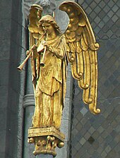 Robed figure of a standing winged angel with two straight trumpets, gazing down