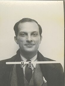 A mug shot style ID photo, with the serial H 0