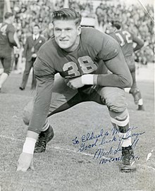 Signed black and white photo of Susoeff in a football stance on a field