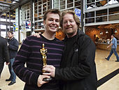 Andrew Stanton and Victor Navone holding the Academy Award for Best Animated Feature