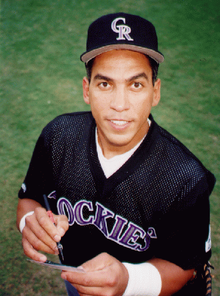 Andrés Galarraga of the Colorado Rockies looks at the camera while signing an autograph