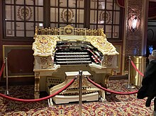 Kings Theatre's organ console behind a velvet rope in the lobby