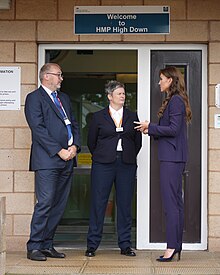 Catherine speaks with authorities outside a men's resettlement prison