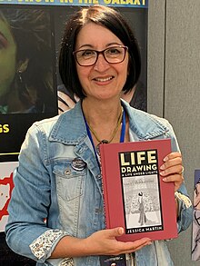 Jessica Martin, holding a copy of her book Life Drawing: A Life Under Lights