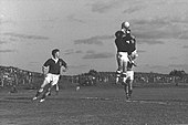 A black and white image of a football match