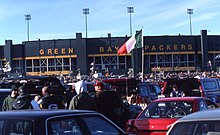 Photo of the outside of Lambeau Field with fans tailgating in the foreground