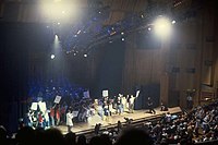 A crowd of people on a stage holding signs