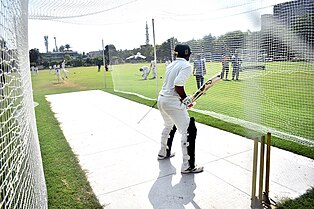 Students playing cricket at UMT.