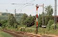 Main signal always showing Hp0; in the background an El6 plate in the catenary and an Sh2 plate at the end of the track
