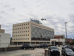 The Medical Center with Helicopter taking off from the rooftop. As viewed from top deck of the Red parking deck facing West.