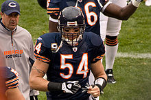 Brian Urlacher on a football field wearing his Chicago Bears uniform and helmet.