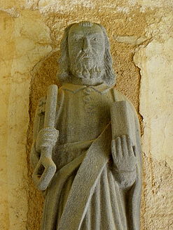 The statue of Saint Peter with key and book in the south porch of the Église Sainte-Nonne.
