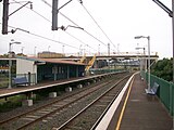 Lysaghts railway station, in Australia, with two side platforms and a footbridge connecting them.