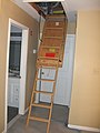 A retractable attic ladder fully extended.