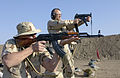 Foreground: A member of the United States Air Force field-qualifying with a USSR AKM in Iraq.