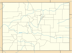 A map of Colorado in light yellow showing county boundaries and major rivers. There is a red dot in the center of Pitkin County, in the west central region of the state.