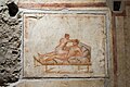 An erotic wall painting on the west wall of a small room at the side of the kitchen from The House of the Vettii, Pompeii. [24]