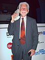 Martin Cooper, demonstrating an old-style mobile phone