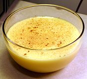A bowl of crème anglaise custard, dusted with nutmeg