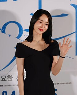 Shin in black dress posing for a camera in May 2019