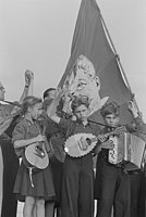 1951, East Berlin, children holding mandolins and accordion in front of a flag (with Stalin's face).