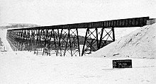view of long railroad viaduct in a snowy landscape