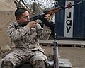 U.S. Marine sights a Zastava M70 with 22mm grenade launcher attached to the muzzle. Note: M59/66 (SKS) to the side which also has 22mm grenade launcher.