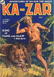 A man in a loincloth prepares to throw a spear, with a lion crouched next to him