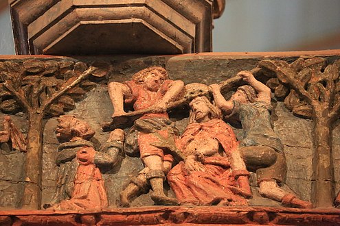 One of the bas-reliefs carved on the rood screen beam: The crown of thorns is forced down on Jesus' head