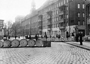 Street barricades during the 1918 November revolution; in the background Landesversicherungs-anstalt building, with its now destroyed tower
